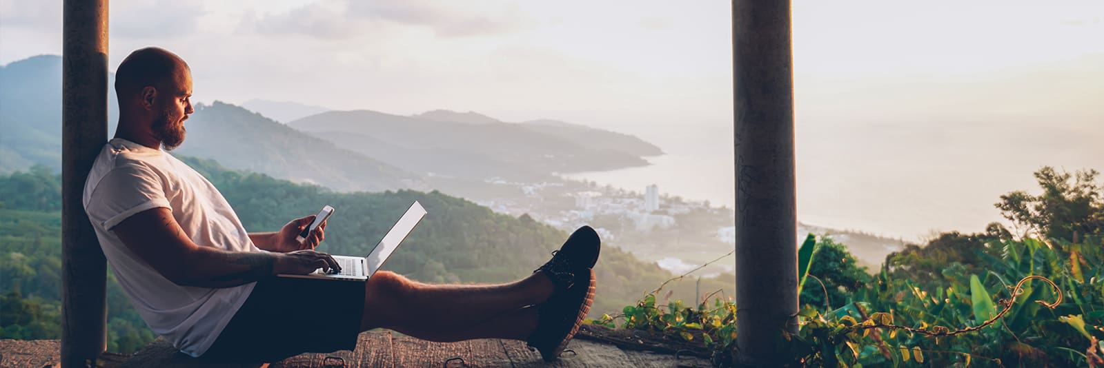 A man designing a website in the mountains - website design trends small business 2026 -Consort Creative: Website Design Services